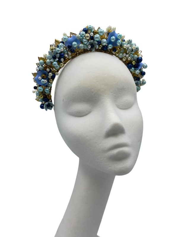 Stunning hand beaded multi-tonal blue crown with gold hardware detail.